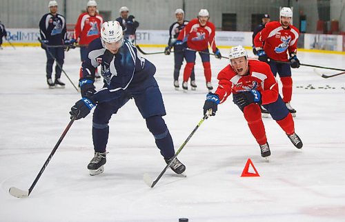 MIKE DEAL / WINNIPEG FREE PRESS
Manitoba Moose' Trent Bourque (38) tries to stick check Thomas Caron (50) during practice at MTS Iceplex Monday morning.
211004 - Monday, October 04, 2021.