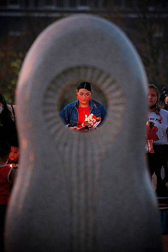 JOHN WOODS / WINNIPEG FREE PRESS
People gather for a vigil and place candles around the Murdered and Missing Women and Girls (MMIWG) monument at the Forks during MMIWG day in Winnipeg Monday, October 4, 2021. 

Reporter: May