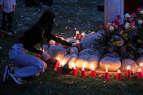 JOHN WOODS / WINNIPEG FREE PRESS
People gather for a vigil and place candles around the Murdered and Missing Women and Girls (MMIWG) monument at the Forks during MMIWG day in Winnipeg Monday, October 4, 2021. 

Reporter: May