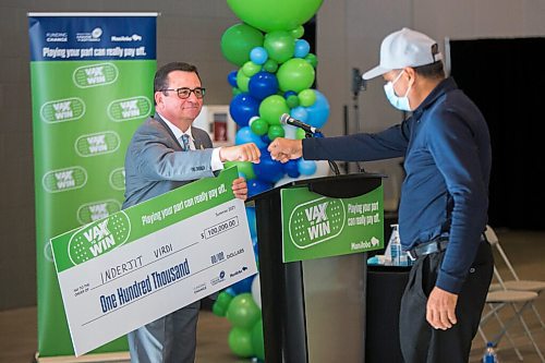 MIKAELA MACKENZIE / WINNIPEG FREE PRESS

Crown services minister Jeff Wharton fist-bumps winner Inderjit Virdi at a Vax to Win event at the RBC Convention Centre vaccination supersite in Winnipeg on Tuesday, Oct. 5, 2021. For Gabby story.
Winnipeg Free Press 2021.