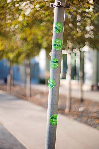 MIKAELA MACKENZIE / WINNIPEG FREE PRESS

COVID-19 vaccination stickers decorate a parking signpost outside of the the RBC Convention Centre vaccination supersite in Winnipeg on Tuesday, Oct. 5, 2021. For Gabby story.
Winnipeg Free Press 2021.