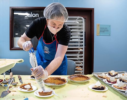 JESSICA LEE / WINNIPEG FREE PRESS

Dallas Holden, a staff member, adds whipped cream to plates of pie at Siloam Mission on October 8, 2021. The organization fed dozens of community members Thanksgiving lunch earlier that day.

Reporter: Erik