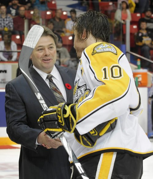 Brandon Sun Brad McCrimmon shakes hands with Brayden Schenn following the ceremonial face-off during Friday night's MasterCard Memorial Cup semi-final game at Westman Place. (Bruce Bumstead/Brandon Sun)