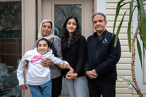 JESSICA LEE / WINNIPEG FREE PRESS

Faiza Malik, 16, poses for a photo on October 13, 2021 at her home with her father Hanifa Malik; mother Mahran Zazai; and sister Rahila.

Reporter: Sabrina




