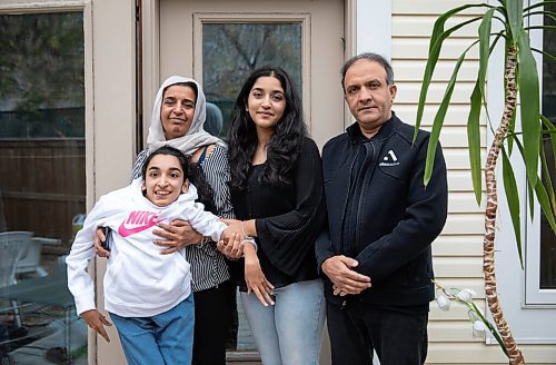 JESSICA LEE / WINNIPEG FREE PRESS

Faiza Malik, 16, poses for a photo on October 13, 2021 at her home with her father Hanifa Malik; mother Mahran Zazai; and sister Rahila.

Reporter: Sabrina




