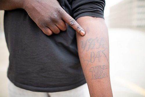 Daniel Crump / Winnipeg Free Press. Rapper Ayii Madit shows some of his tattoos including one he had done in memory of his mom, Yar, who died of cancer in 2004. Some of his tattoos are professionally done and the rest are stick and poke pieces done while Madit was serving time in prison. October 15, 2021.