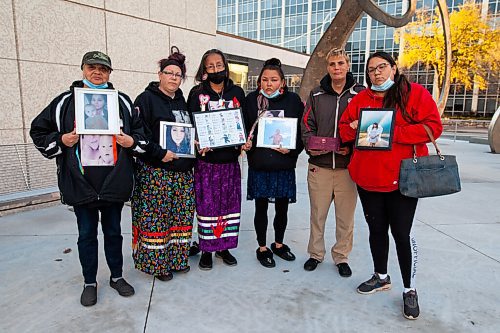 Daniel Crump / Winnipeg Free Press. (L to R) Yvonne Caron, Lisa Hargreaves, Candy Volk, Jessica Bird, Lee Atwell and Cathy Bird. Family and friends of the victims hold photos and keepsakes after a day of impact statements at the sentencing hearing for Armand Chartrand, who is convicted of criminal negligence causing death when he fled a traffic stop and killed a mother and her young infant. October 15, 2021.