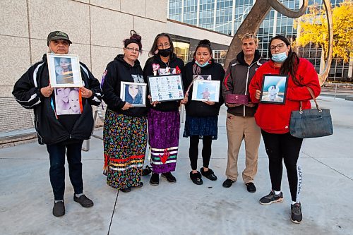 Daniel Crump / Winnipeg Free Press. (L to R) Yvonne Caron, Lisa Hargreaves, Candy Volk, Jessica Bird, Lee Atwell and Cathy Bird. Family and friends of the victims hold photos and keepsakes after a day of impact statements at the sentencing hearing for Armand Chartrand, who is convicted of criminal negligence causing death when he fled a traffic stop and killed a mother and her young infant. October 15, 2021.