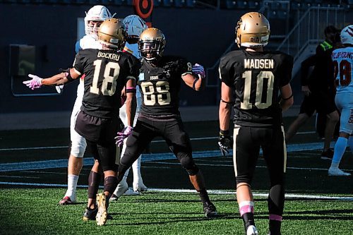 Daniel Crump / Winnipeg Free Press. The Bisons celebrate a touchdown to take the lead after Birhanu Yitna (88) scores a late touch down to begin a comeback. University of Manitoba Bisons take on the University of Calgary Dinos at IG Field in Winnipeg. October 16, 2021.