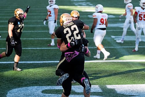 Daniel Crump / Winnipeg Free Press. The Bisons celebrate a touchdown to take the lead after Breydon Stubbs (22) carried the ball over the line to take a late game lead. University of Manitoba Bisons take on the University of Calgary Dinos at IG Field in Winnipeg. October 16, 2021.