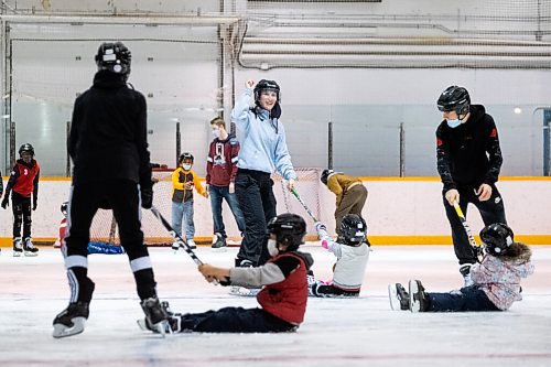 Daniel Crump / Winnipeg Free Press. Tara Eriksen helps organize some fun as young newcomers learn to  skate at the Winnipeg Newcomer Sport Academy at Charlie Gardiner Arena on Saturday morning. The Academy is a not for profit organization in Winnipeg dedicated to getting kids involved in sport who are new to Canada. October 16, 2021.