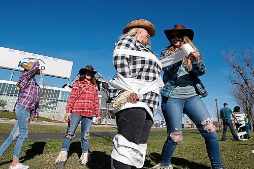 JOHN WOODS / WINNIPEG FREE PRESS
Tammy Gulle, gets mummified by Cherish Sanclemente, (blue) Jaydee Sanclemente, (purple) and Vicky Sanclemente, (red) as they take part in the Quest4CF Family Scavenger Hunt throughout South Winnipeg Sunday, October 17, 2021. The event was to raise funds and bring awareness to Cystic Fibrosis (CF) research and two petitions for circling for Manitoba to fund CF drugs and to support CF families.

Reporter: SU