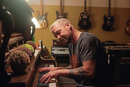 Canstar Community News Rusty Matyas plays piano at Argyle Studio. He's a recent arrival to the studio owned by Cam Loeppky. The studio is housed in a warehouse formerly for mobile campers and provides warmth to an otherwise cold building.
