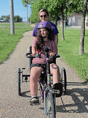 Canstar Community News Oct. 13, 2021 - Ema Guimond and her mother Trish, are going for a bike ride using Ema's specialized bike. The Guimonds are one of 17 families in the province treating a family member with the rare condition. (SUPPLIED PHOTO)