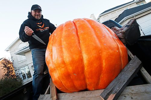 JOHN WOODS / WINNIPEG FREE PRESS
Chris Okell prepares to carve up one of his 500 lb pumpkins at his home in Winnipeg Tuesday, October 19, 2021. Okell raises money for Cancer Care.

Reporter: Piche