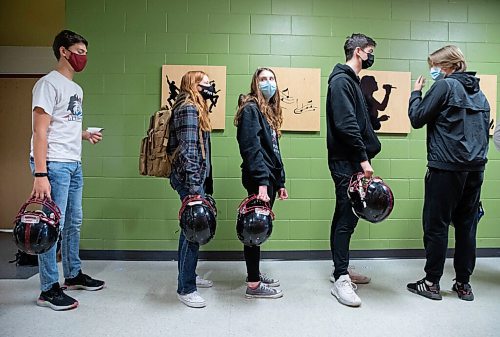 JESSICA LEE / WINNIPEG FREE PRESS

Sturgeon Heights Football students (from left to right) Vincent Campbell, Kianna Truthwaite, Daysha Papunen, Carter Esch and Brennan McCammon line up to have their helmets stickered on October 21, 2021, in preparation for the next days game.

Reporter: Mike






