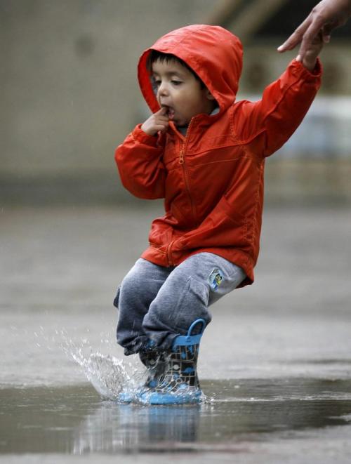 MIKE.DEAL@FREEPRESS.MB.CA 100528 - Friday, May 28th, 2010 Two-year-old Ajai Sandhu jumps in the puddles from this mornings thunder showers while on a visit to The Forks. MIKE DEAL / WINNIPEG FREE PRESS