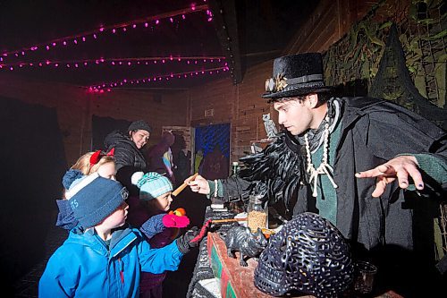 Mike Sudoma / Winnipeg Free Press
Merlin the magician (right) hands a candy mealworm to Brody (left and front) at Boo at the Zoo Wednesday evening
October 27, 2021