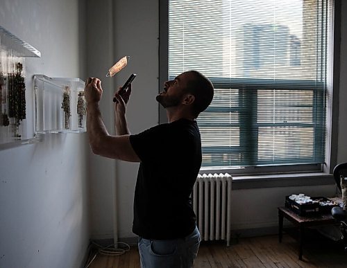 JESSICA LEE / WINNIPEG FREE PRESS

Chris Dorosz shows an example of a newspaper clipping which he has poked holes into on November 1, 2021 in his studio in downtown Winnipeg. The viewer is meant to manipulate the piece using a flashlight and make shadows on a wall.

Reporter: Alan






