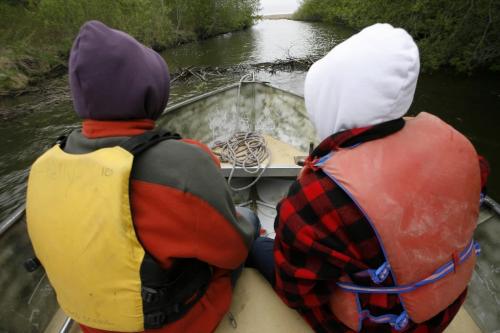 MIKE.DEAL@FREEPRESS.MB.CA 100519 - Wednesday, May 19th, 2010 OPASKWAYAK CREE NATION Students from the land-based education course at Joe E. Ross School. Zach Fontaine (left) and Gordon Niquanicappo (right) watch and get ready for the bump as the boat approaches the beaver dam.  See Nick Martin story. MIKE DEAL / WINNIPEG FREE PRESS