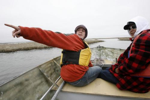MIKE.DEAL@FREEPRESS.MB.CA 100519 - Wednesday, May 19th, 2010 OPASKWAYAK CREE NATION Students from the land-based education course at Joe E. Ross School. Zach Fontaine (left) points to the way out of the lake system while sitting at the bow of the boat with Gordon Niquanicappo (right) while out searching for Mud Hen eggs for the community feast. See Nick Martin story. MIKE DEAL / WINNIPEG FREE PRESS
