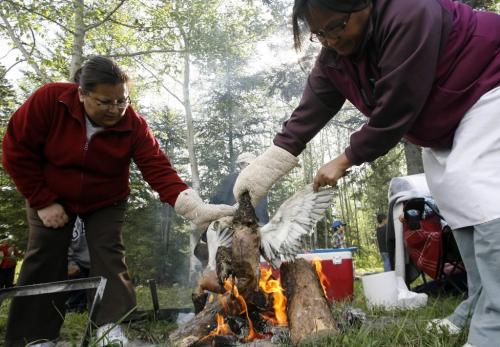 MIKE.DEAL@FREEPRESS.MB.CA 100520 - Thursday, May 20th, 2010 OPASKWAYAK CREE NATION Judy Campbell (left) and Veronica Lathlin (right) burn the feathers off of a pair of ducks that will be cooked for the traditional camp and community feast hosted by Joe E. Ross School. See Nick Martin story. MIKE DEAL / WINNIPEG FREE PRESS