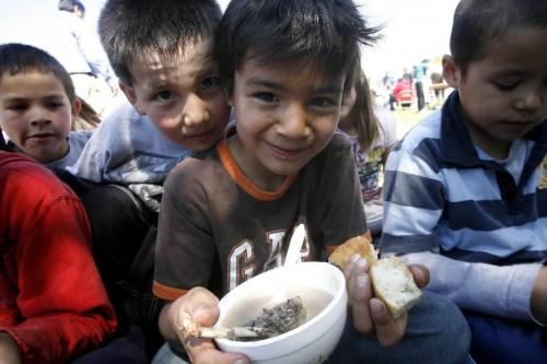 MIKE.DEAL@FREEPRESS.MB.CA 100520 - Thursday, May 20th, 2010 OPASKWAYAK CREE NATION Chase Genaille, 7, looks over the shoulder of Brandon Bignell, 8, who is holding his lunch of duck soup and baked bannock while at the Joe E. Ross School traditional camp and community feast. See Nick Martin story. MIKE DEAL / WINNIPEG FREE PRESS