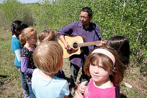 MIKE.DEAL@FREEPRESS.MB.CA 100520 - Thursday, May 20th, 2010 OPASKWAYAK CREE NATION Joe Lathlim a teacher at Joe A. Ross school, who teaches music on his own time goes over a song some students plan to sing during the  traditional camp and community feast. See Nick Martin story. MIKE DEAL / WINNIPEG FREE PRESS