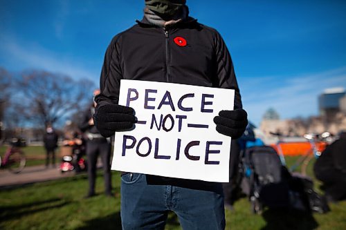 Daniel Crump / Winnipeg Free Press. A person holds a sign that reads peace not police during the BIPOC Families Against Police rally at the Manitoba Legislature in Winnipeg on Saturday. November 6, 2021.