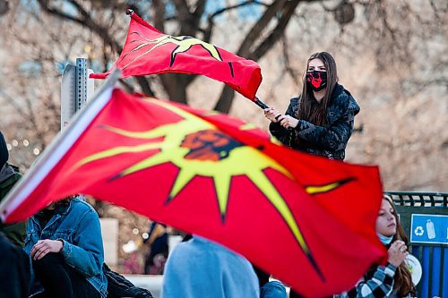 Daniel Crump / Winnipeg Free Press. Demonstrators wave the Mohawk flag during the BIPOC Families Against Police rally at the Manitoba legislature in Winnipeg on Saturday. November 6, 2021.