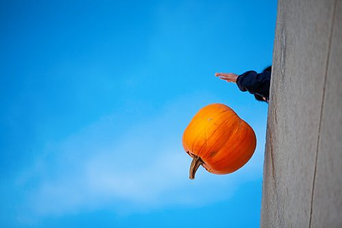 Daniel Crump / Winnipeg Free Press. Someone drops their pumpkin from the second story of the Polo Park parkade Saturday morning as part of the Compost Manitoba Pumpkin Drop. The pumpkins are later composted or donated to local farm as feed for animals. November 6, 2021.
