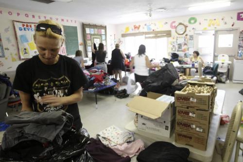 MIKE.DEAL@FREEPRESS.MB.CA 100603 - Thursday, June 3nd, 2010 Leah McGuiness and several other volunteers sort through donated clothing at the Family Centre located amoungst the Manitoba Housing apartment blocks that was affected by sewage backup during the heavy rain falls from last weekend in south Transconna. MIKE DEAL / WINNIPEG FREE PRESS