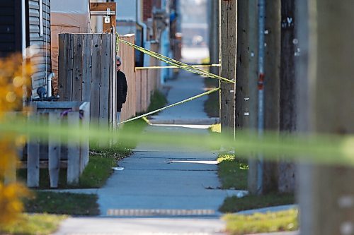 JOHN WOODS / WINNIPEG FREE PRESS
A resident peaks around a fence as police investigate at the scene of a homicide at Burrows and Aikens in Winnipeg on Sunday, November 7, 2021. 

Re: Thorpe