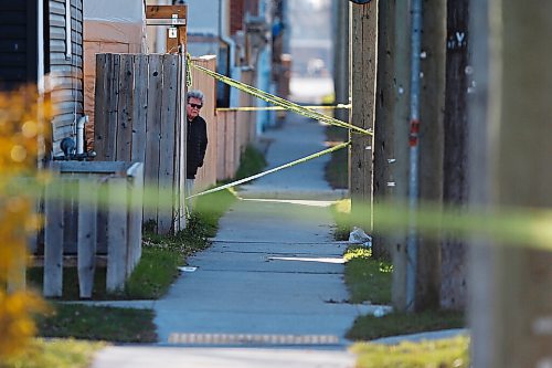 JOHN WOODS / WINNIPEG FREE PRESS
A resident peaks around a fence as police investigate at the scene of a homicide at Burrows and Aikens in Winnipeg on Sunday, November 7, 2021. 

Re: Thorpe