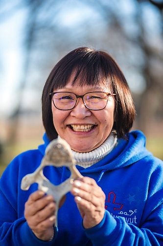 MIKAELA MACKENZIE / WINNIPEG FREE PRESS

Inuit carver Goota Ashoona, who comes from a long line of artists and whose scupture lives outside of Qaumajuq, poses for a portrait with a newly finished whalebone carving in her yard near Elie on Tuesday, Nov. 9, 2021. For Jen story.
Winnipeg Free Press 2021.