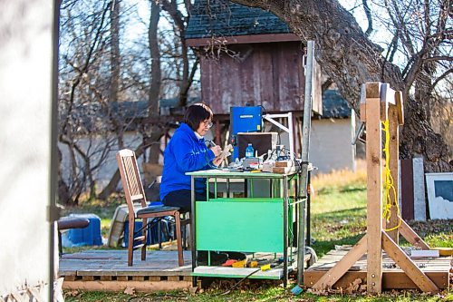 MIKAELA MACKENZIE / WINNIPEG FREE PRESS

Inuit carver Goota Ashoona, who comes from a long line of artists and whose scupture lives outside of Qaumajuq, carves whalebone in her yard near Elie on Tuesday, Nov. 9, 2021. For Jen story.
Winnipeg Free Press 2021.