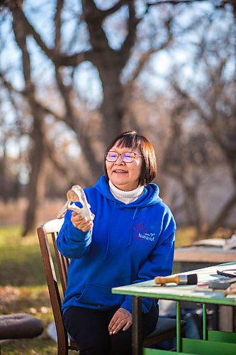 MIKAELA MACKENZIE / WINNIPEG FREE PRESS

Inuit carver Goota Ashoona, who comes from a long line of artists and whose scupture lives outside of Qaumajuq, poses for a portrait with a newly finished whalebone carving in her yard near Elie on Tuesday, Nov. 9, 2021. For Jen story.
Winnipeg Free Press 2021.