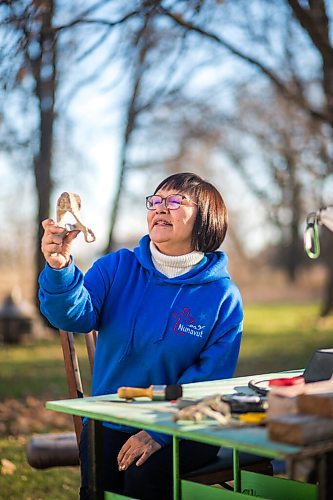 MIKAELA MACKENZIE / WINNIPEG FREE PRESS

Inuit carver Goota Ashoona, who comes from a long line of artists and whose scupture lives outside of Qaumajuq, poses for a portrait with a newly finished whalebone carving in her yard near Elie on Tuesday, Nov. 9, 2021. For Jen story.
Winnipeg Free Press 2021.