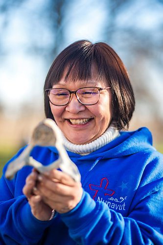 MIKAELA MACKENZIE / WINNIPEG FREE PRESS

Inuit carver Goota Ashoona, who comes from a long line of artists and whose scupture lives outside of Qaumajuq, poses for a portrait with a newly finished whalebone carving in her yard near Elie on Tuesday, Nov. 9, 2021. For Jen story.
Winnipeg Free Press 2021.