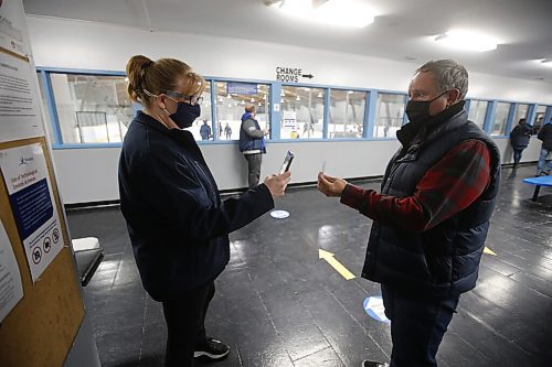 JOHN WOODS / WINNIPEG FREE PRESS
Trish Buhler, hockey mum and manager of St Boniface Seals, scans the vaccination card of Shaun Chornley, the president of the St Boniface Minor Hockey Association, as he enters the Bertrand Arena on Tuesday, November 9, 2021. Chornley and others feel that using volunteers to scan vaccination cards at city arenas is risky.

Re: Pursaga