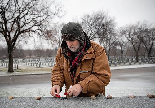 JESSICA LEE / WINNIPEG FREE PRESS

Brian Grant, served with the Royal Canadian Navy. He places a poppy at a memorial at the Field of Honour at Brookside Cemetery on November 10, 2021. His father and grandfather were also veterans.





