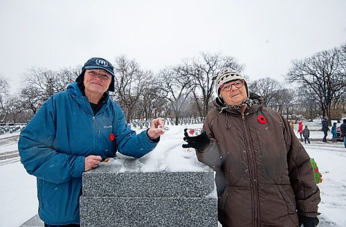 Mike Sudoma / Winnipeg Free Press
Neighbours (left to right) Helen Grant and Maureen Dowds lay painted stones representing their family members who served in the forces ontop of the Stone of Remembrance prior to a Remembrance Day service at brookside Cemetery Thursday morning
November 11, 2021