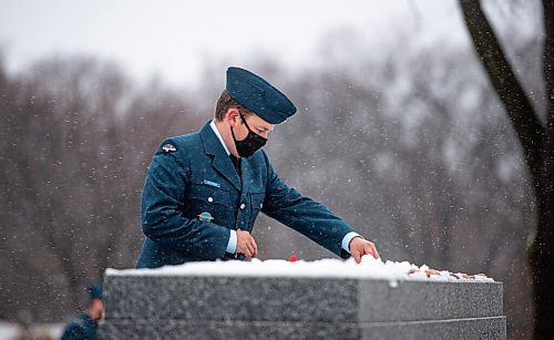 Mike Sudoma / Winnipeg Free Press
Aviator Mathews lays down his poppy on top of the Stone of Remembrance after a Remembrance Day service at brookside Cemetery Thursday morning
November 11, 2021
