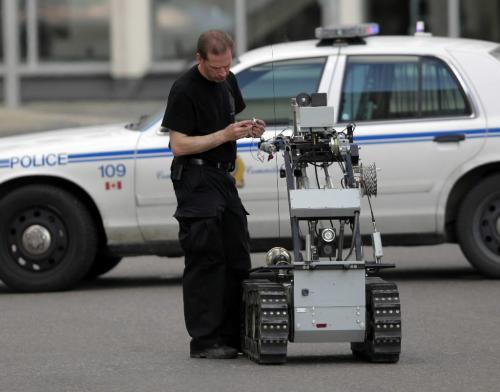 BORIS.MINKEVICH@FREEPRESS.MB.CA  100606 BORIS MINKEVICH / WINNIPEG FREE PRESS Police bomb squad get's Dean the robot ready to blow up a suspicous suitcase at Portage and Garry.