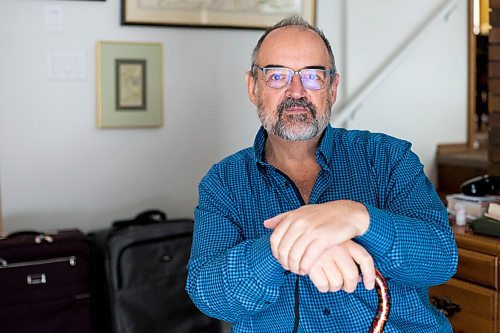 MIKAELA MACKENZIE / WINNIPEG FREE PRESS

Max Johnson poses for a portrait in his home (with the suitcases from travelling) after coming back from Lithuania, where he went to get knee surgery, in Winnipeg on Wednesday, Nov. 17, 2021. For Kevin story.
Winnipeg Free Press 2021.