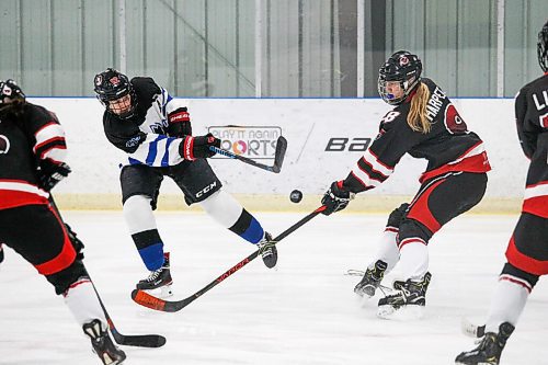 Daniel Crump / Winnipeg Free Press. College Jeanne-Suaves Annika Devine (12) shoots the puck during the first period. Winnipeg Womens High School Hockey League hockey Jeanne-Suave Olympiens vs. Beliveau Barracudas at the Southdale Arena in Winnipeg. November 17, 2021.