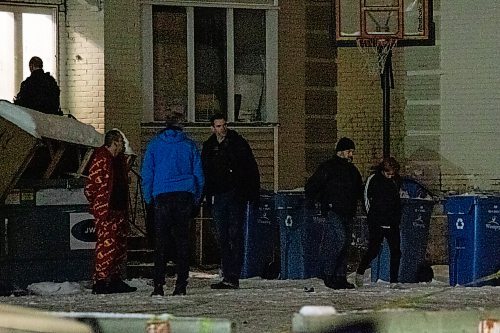 Daniel Crump / Winnipeg Free Press. Winnipeg police bring two handcuffed people out of an apartment block at 363 Mountain avenue following a standoff. November 17, 2021.