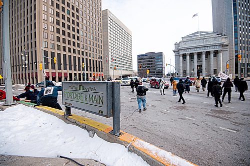 Mike Sudoma / Winnipeg Free Press
Protestors jump down from a barricade at Portage and Main as the All Out for WedzinKwa rally begins Friday afternoon
November 19, 2021