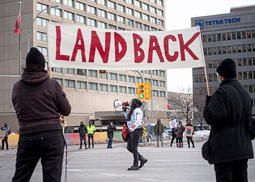 Mike Sudoma / Winnipeg Free Press
Sadie-Pheonix Lavoie speaks as protestors hold up a Land Back sign during the All Out for WedzinKwa rally at Portage and Main Friday afternoon
November 19, 2021