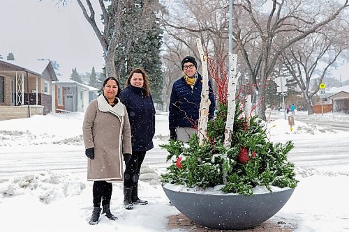 Canstar Community News (From left) Coun. Devi Sharma, Sabyna Sawka, owner of Petals Flowers & Gifts, and Daniel Guenther show off the new winter arrangement at Forest Park Drive and Sinclair Street.